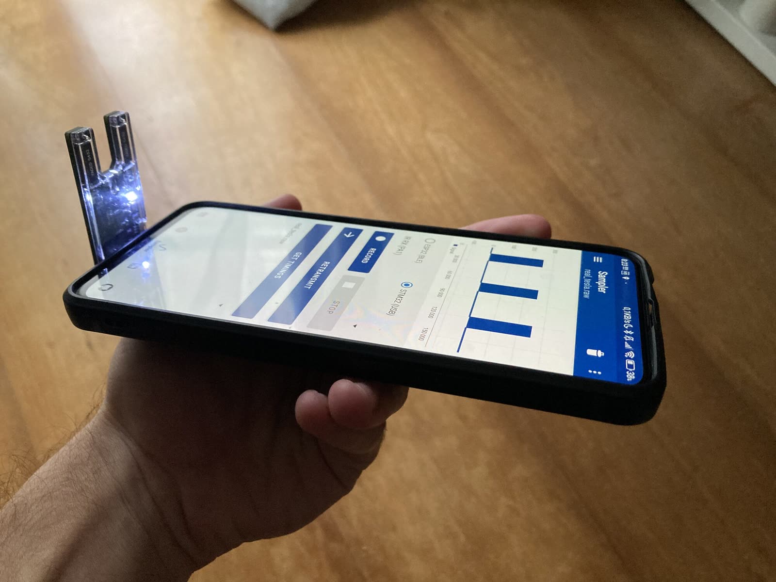 The board plugged into a phone, seen from the side
